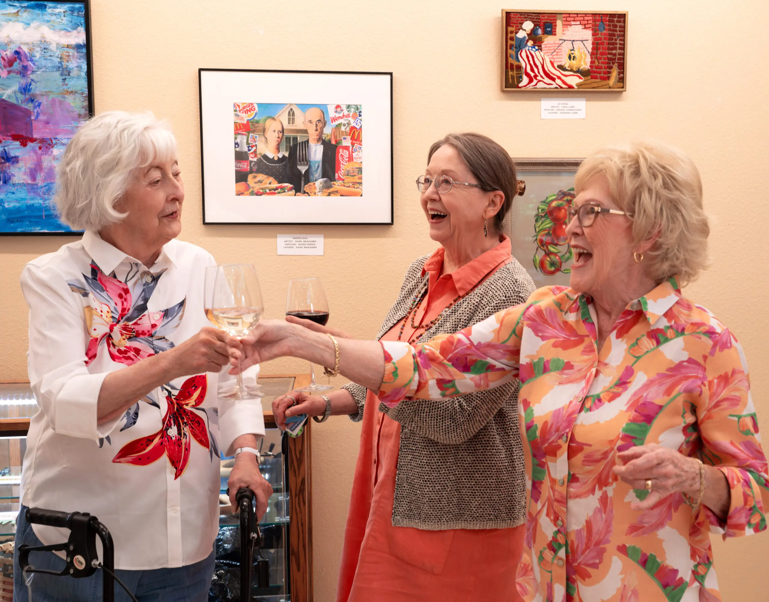 An elderly man wearing a “Dakota” cap working at a woodshop bench, leaning over a red vise with a wooden ladder and tools behind him.
